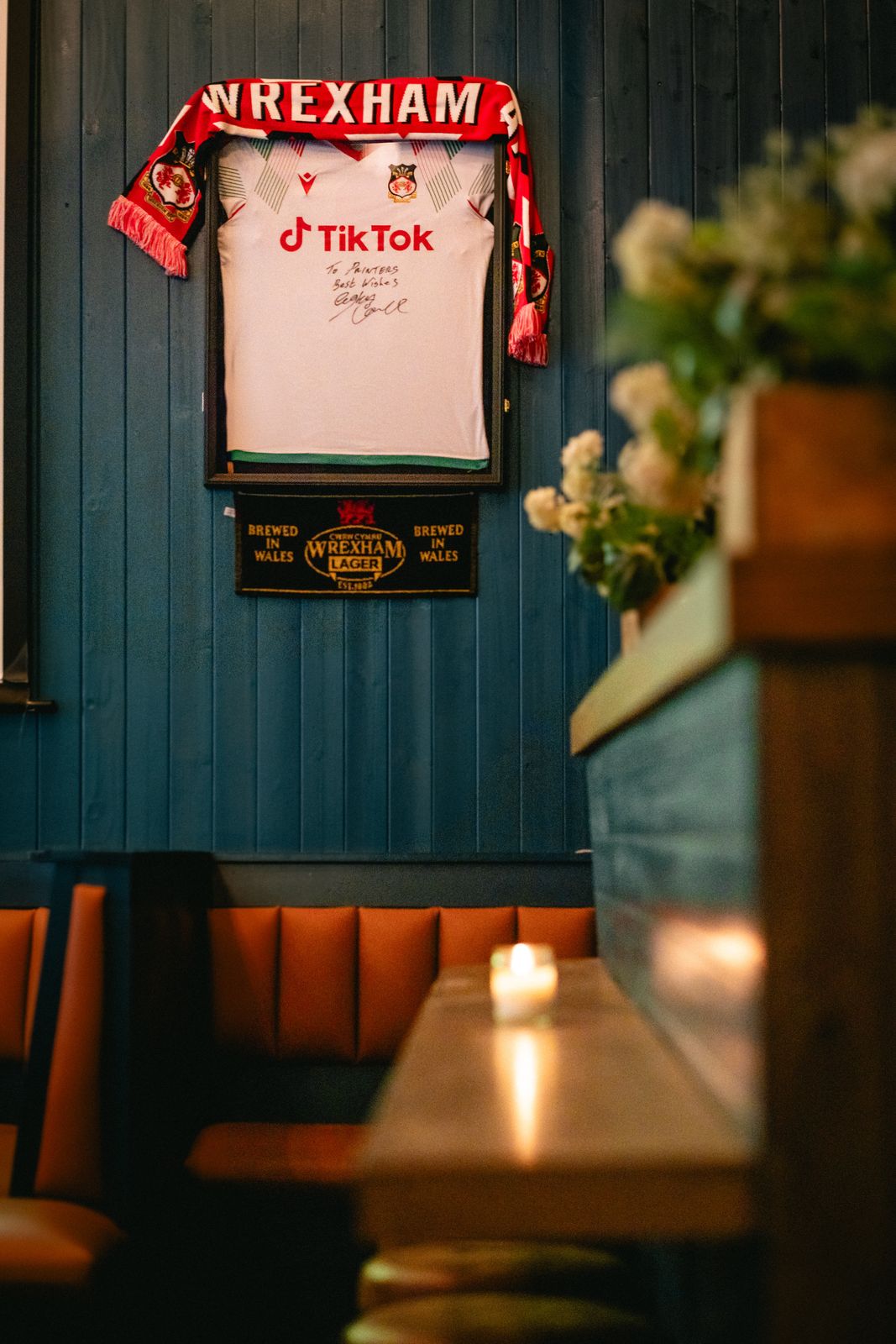 A signed, framed Wrexham AFC shirt and scarf on display at Printers Alley
